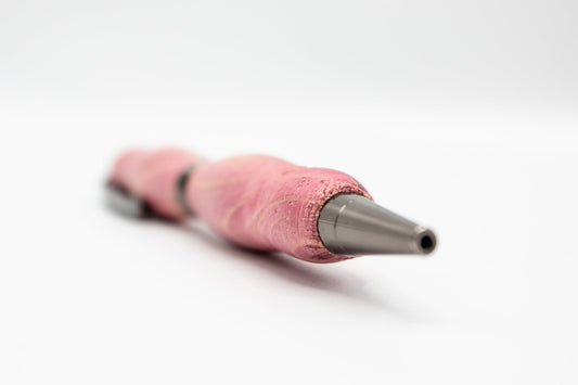 Handcrafted pink stained wood pen from BuyNebraska.com, featuring smooth finish and elegant design, perfect for home and garden use.