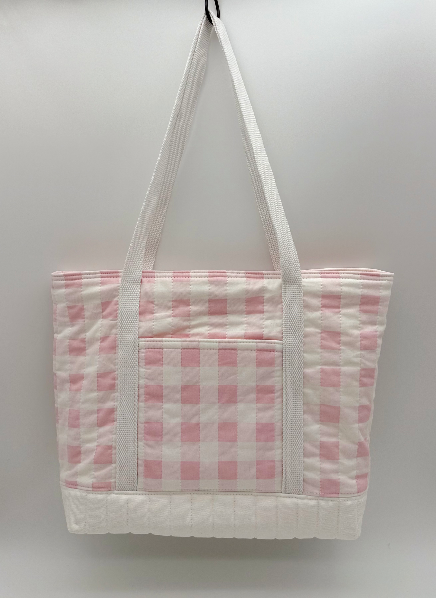 Back view of a pink gingham quilted canvas tote bag with snap closure, handmade by C2 Creations LLC.