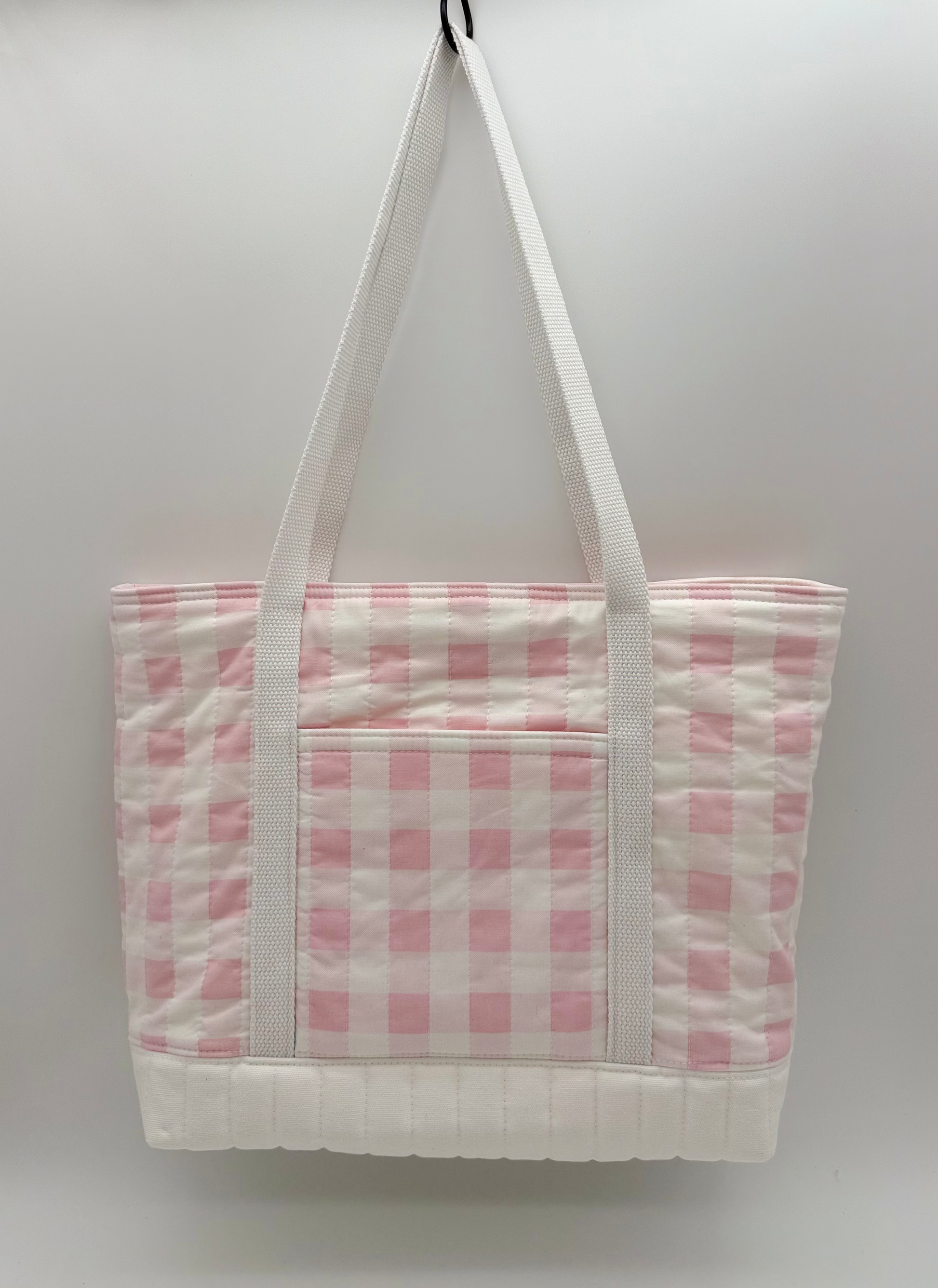 Back view of a pink gingham quilted canvas tote bag with snap closure, handmade by C2 Creations LLC.