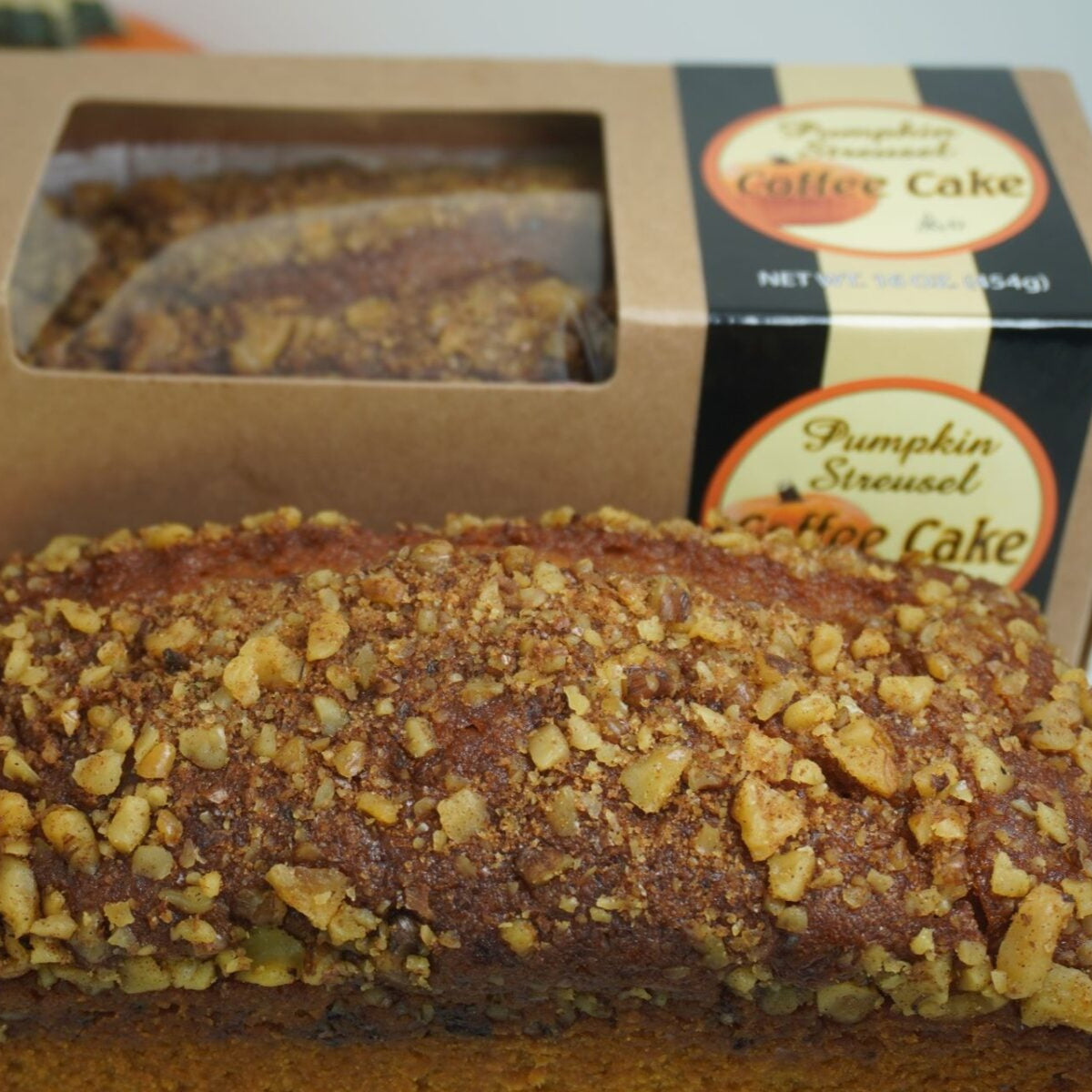 Slice of pumpkin streusel coffee cake from Beatrice Bakery, showcasing moist cake topped with pumpkin and crumbly streusel.
