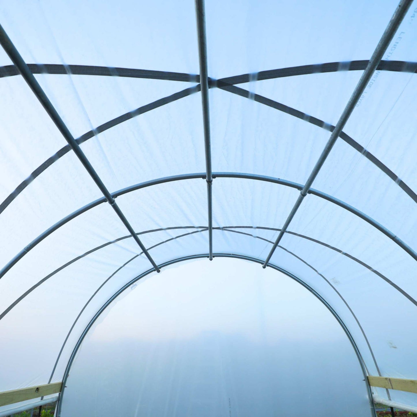 Bootstrap Farmer purlin kit for hobby greenhouse, showing metal purlins installed on hoop house structure.