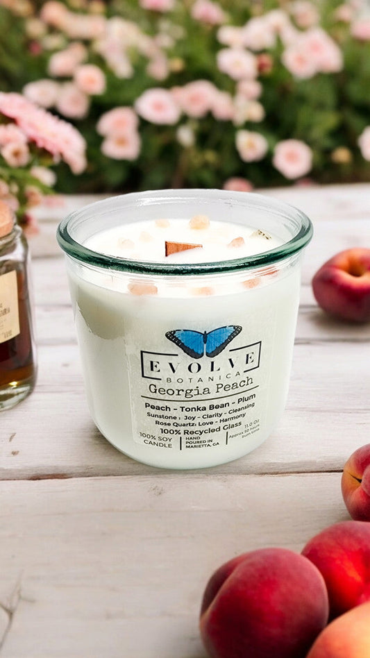 Evolve Botanica Georgia Peach Rocks Candle with wood wick and gemstone accents, soy wax, in a cozy lifestyle setting.