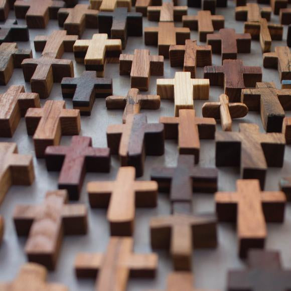 Handmade wooden pocket cross from Dennehey Design Co. featuring a detailed wooden cross with rosary beads.