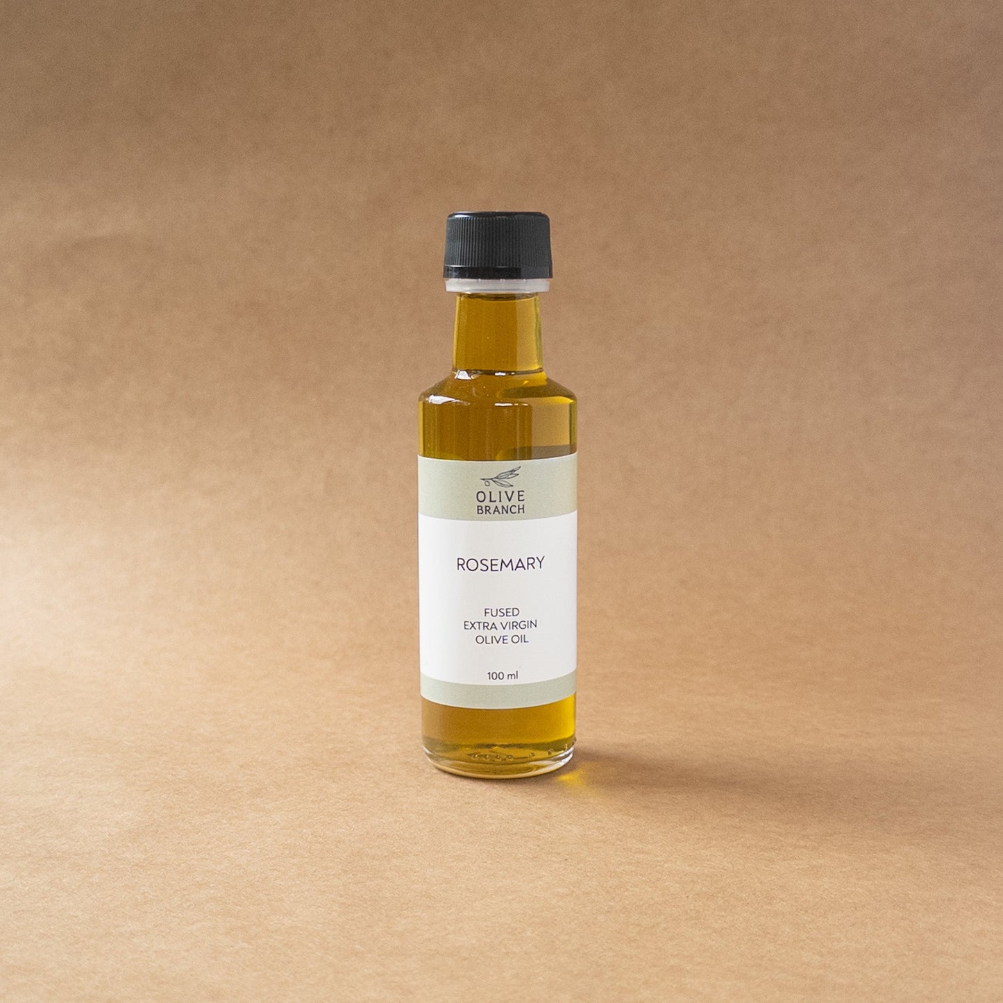 Bottle of Olive Branch Oil & Spice Rosemary Fused Extra Virgin Olive Oil with fresh rosemary sprigs and a rustic background