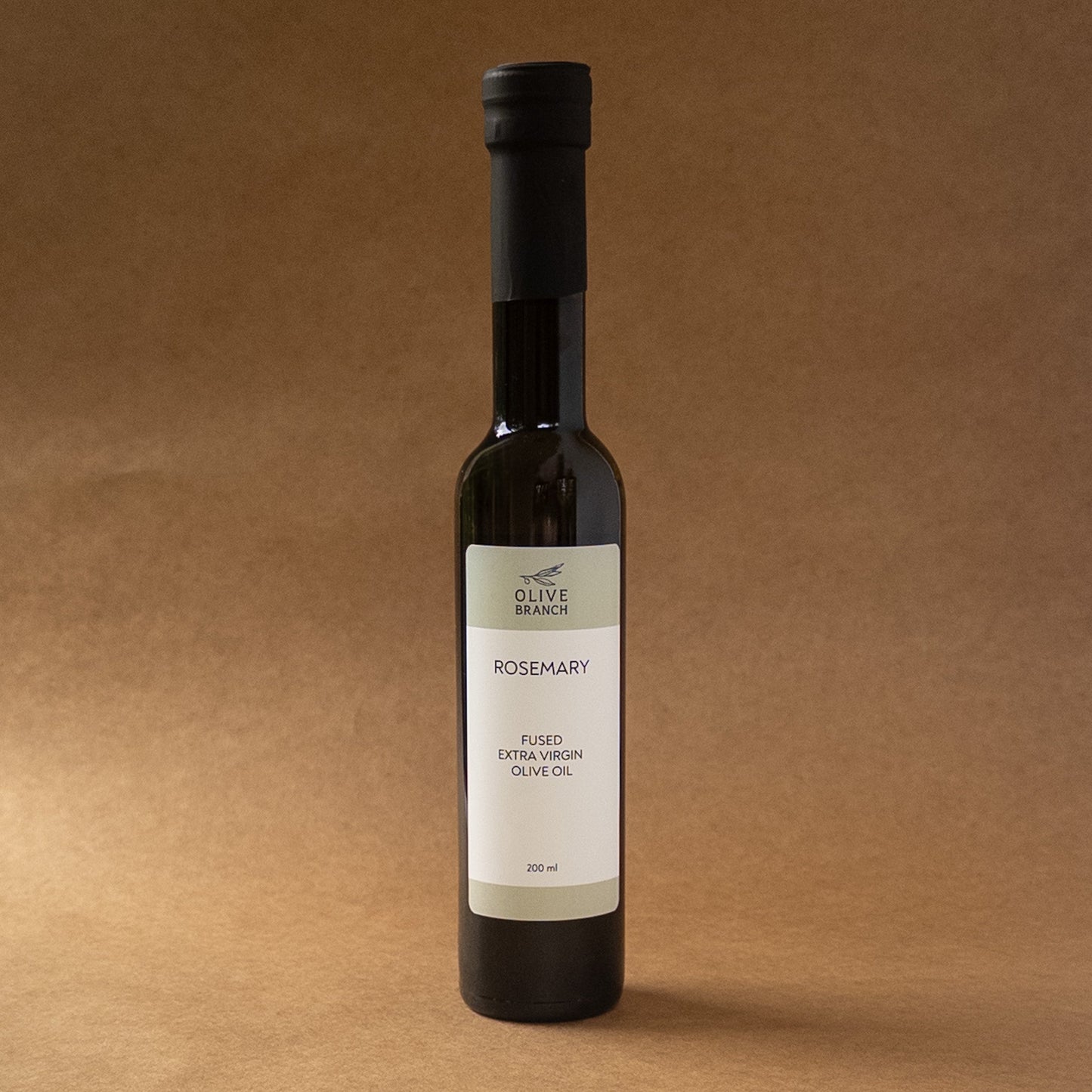 Bottled Rosemary Fused Extra Virgin Olive Oil from Olive Branch Oil & Spice, with fresh rosemary herbs infused in golden olive oil.