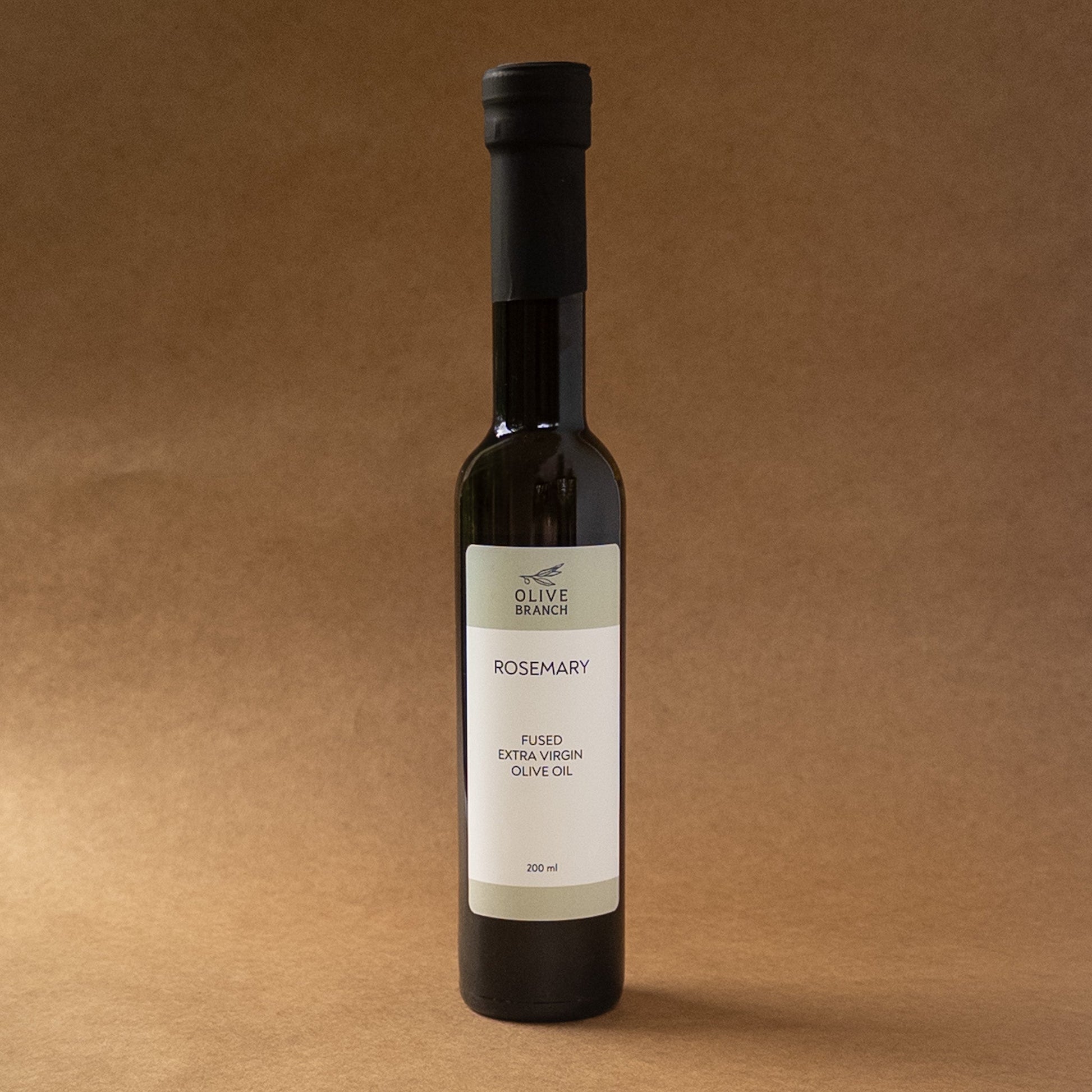 Bottled Rosemary Fused Extra Virgin Olive Oil from Olive Branch Oil & Spice, with fresh rosemary herbs infused in golden olive oil.