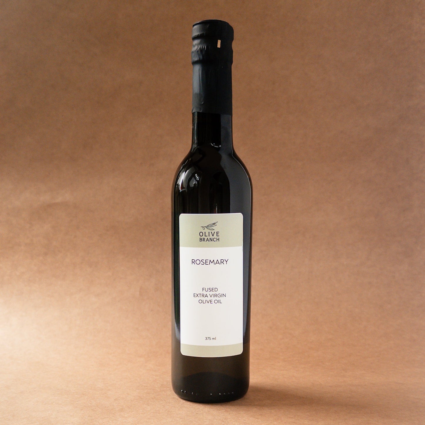 Bottle of Olive Branch Oil & Spice Rosemary Fused Extra Virgin Olive Oil, featuring fresh rosemary herbs infused in green olive oil.