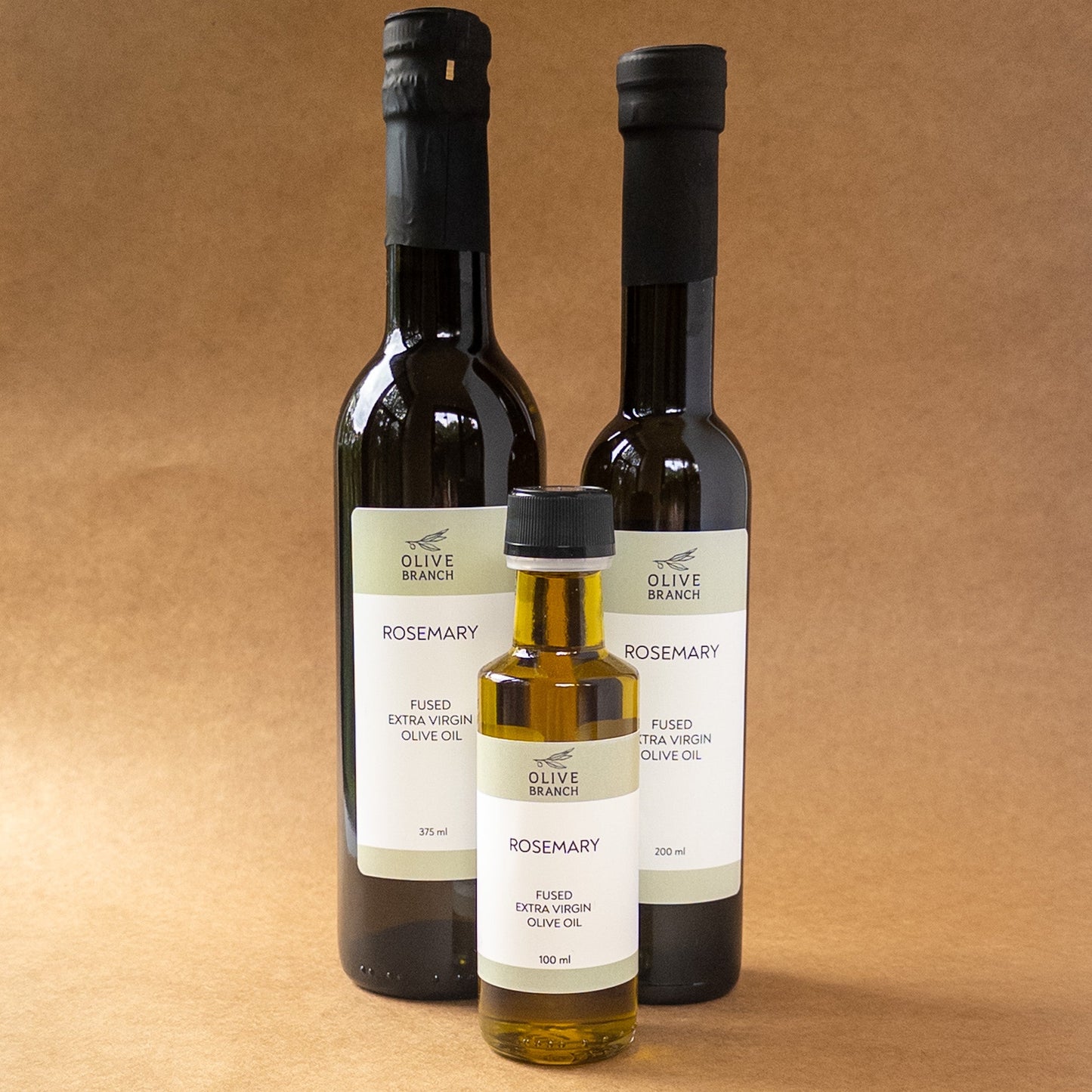 Bottle of Olive Branch Oil & Spice Rosemary Fused Extra Virgin Olive Oil showing the label and clear glass bottle.