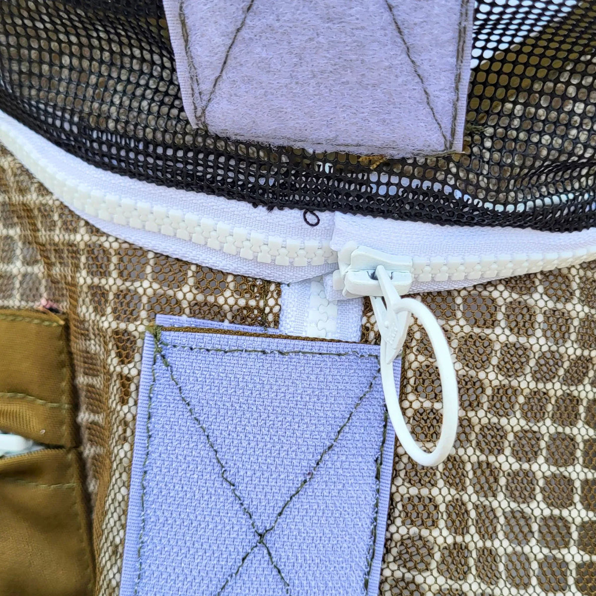 Round beekeeping veil by Foxhound Bee Company, protective fencing-style hat with mesh face shield for safe hive handling.