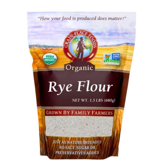 Organic rye flour bag from Grain Place Foods, 1.5 lb, non-GMO, displayed in a kitchen setting with a rustic background.