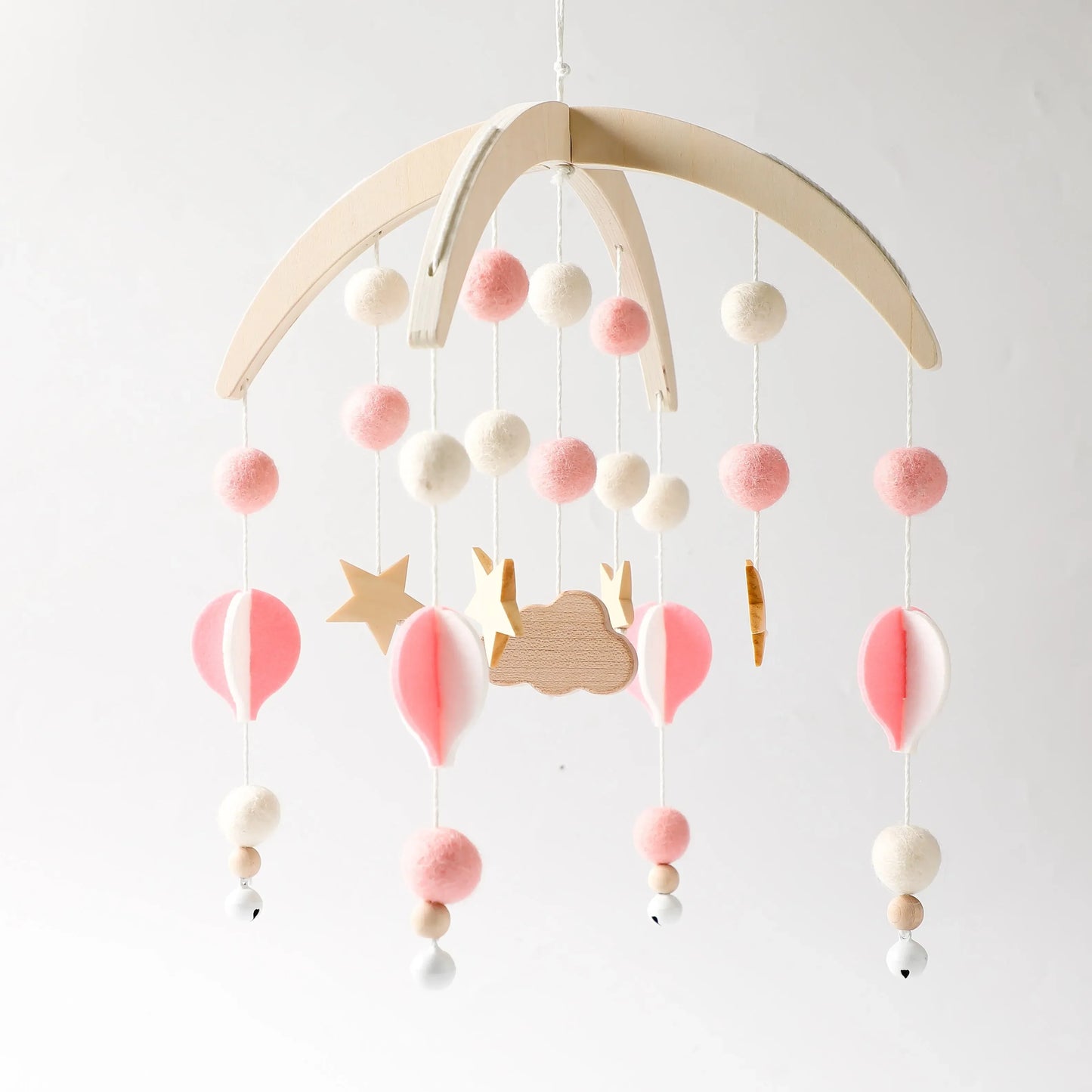 Wooden mobile hanging toys by Petite Pioneers, featuring colorful animal and star shapes suspended on a wooden frame.