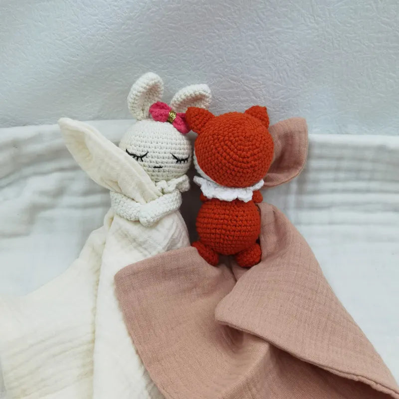 Baby bib with sleeping animals and rattle by Petite Pioneers, featuring soft fabric and cute animal designs for infants.