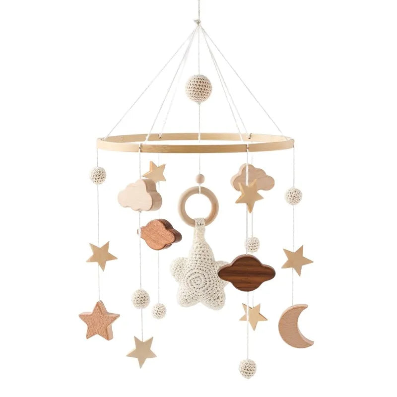 Wooden mobile hanging toys by Petite Pioneers, featuring colorful animal and star shapes on a natural wooden frame.