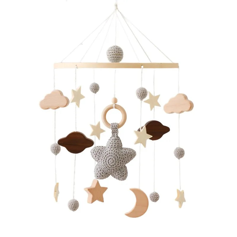 Wooden mobile hanging toys by Petite Pioneers featuring colorful painted animal and star shapes for baby crib decoration.