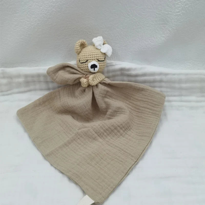 Baby bib with sleeping animal print and attached rattle from Petite Pioneers, soft fabric with cute animal designs.