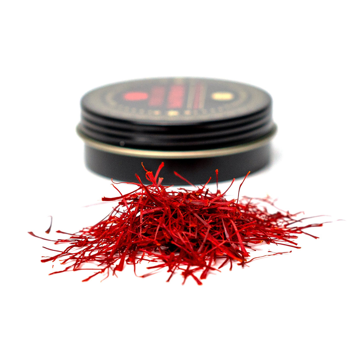 Premium super Negin saffron threads from Vanilla Bean Kings, showcasing vibrant red saffron strands on a white background.