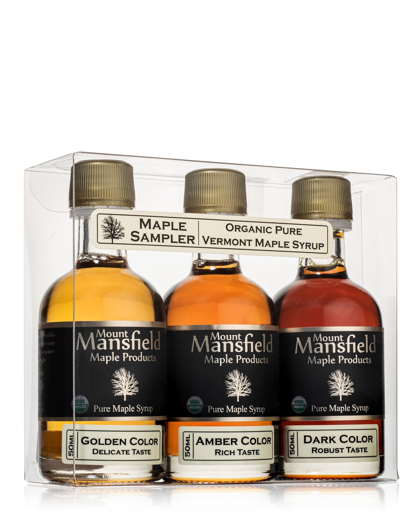 Assorted bottles of Mount Mansfield Maple Products organic pure Vermont maple syrup sampler in a wooden box.