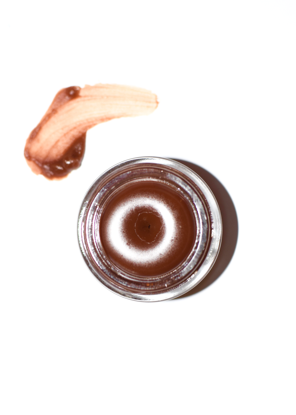Cocoa lip gloss by plant makeup showing a glossy, cocoa-colored lip gloss tube with a clear label and product name.