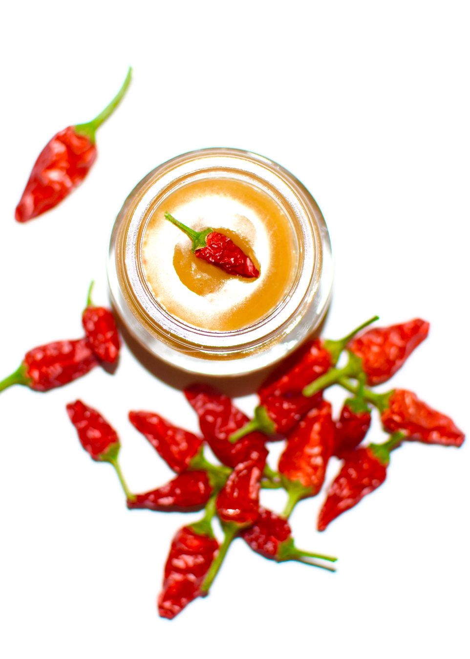 Plant Makeup Chili Lip Tinglin' Gloss with shiny, tingling lip gloss in a clear container with a black cap.