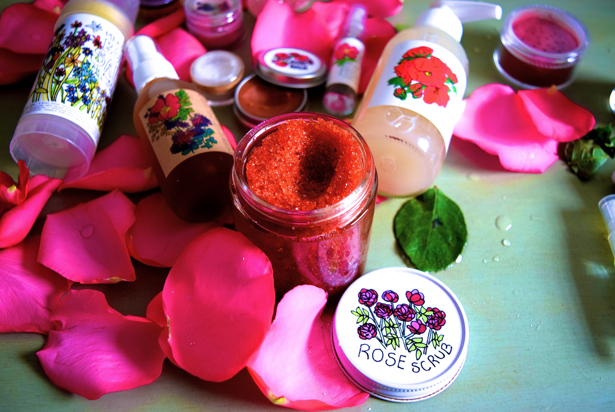 Plant Makeup Beach Rose Scrub jar with rose petals and natural exfoliants visible in a clear container on a neutral background.