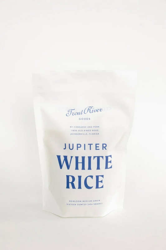 Close-up of white rice grains from Congaree and Penn's Jupiter White Rice, showing individual grains in a natural setting.