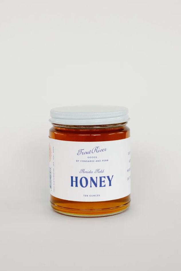 Jar of Congaree and Penn honey preserves with golden honey visible, showcasing the natural, thick preserve texture.
