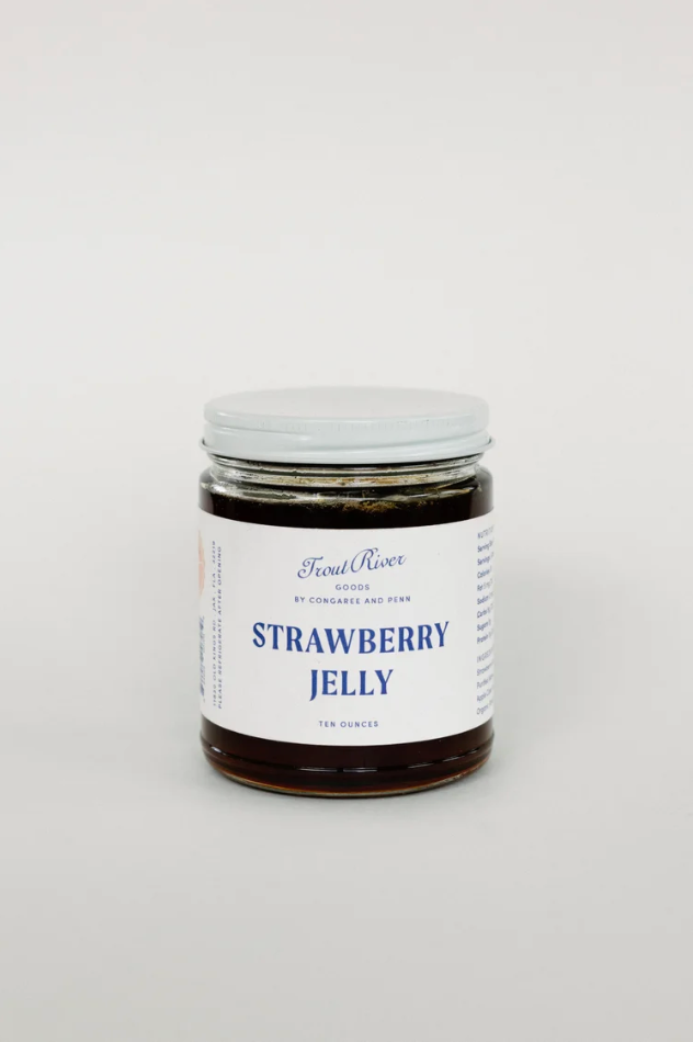 Jar of Congaree and Penn strawberry jelly preserves with a clear label showcasing fresh strawberries and vibrant red color.