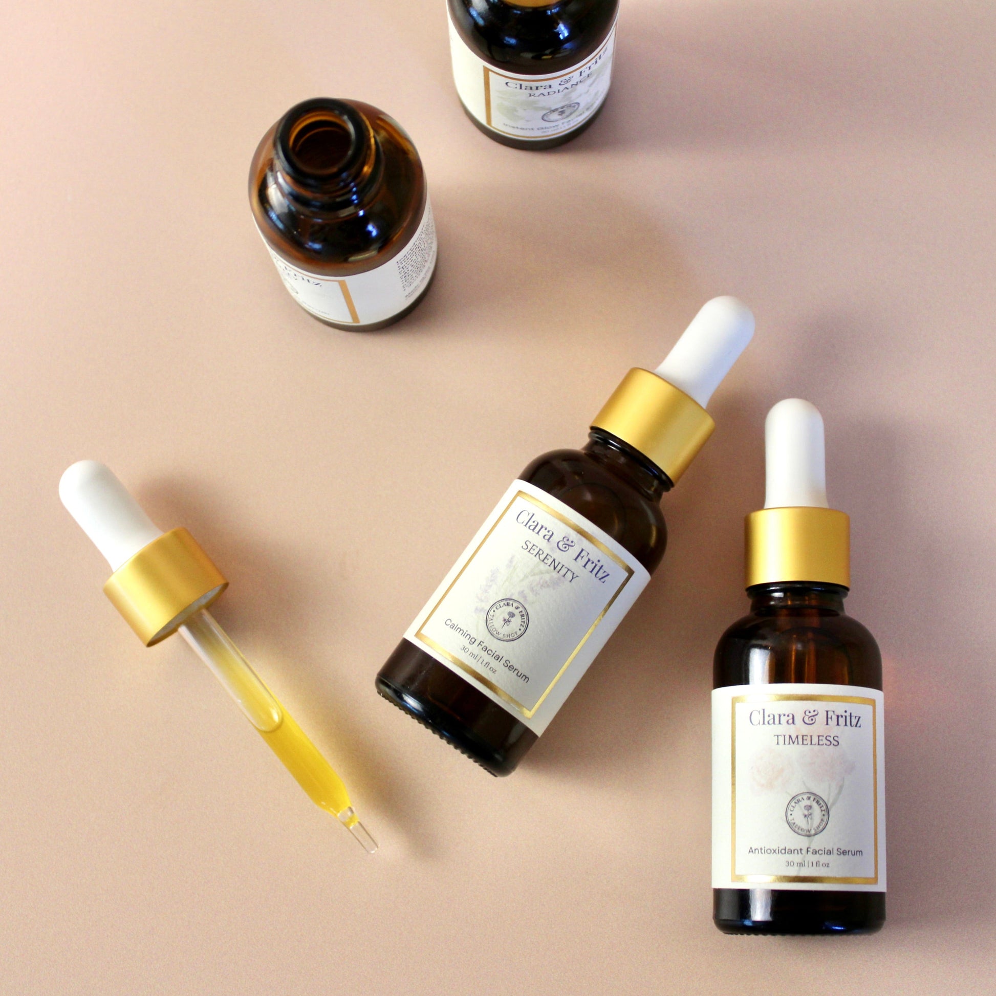 Clara & Fritz Tallow Shop Serenity Calming Facial Serum trio in elegant bottles, designed for soothing and moisturizing skin.