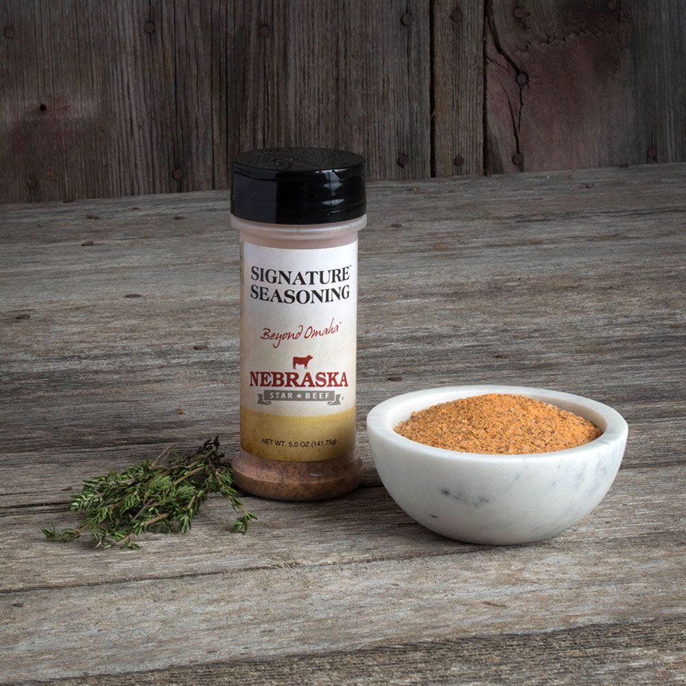BuyNebraska.com Honest Value beef package with signature seasoning, featuring 5 oz spice jar and cuts of top sirloin and patties.