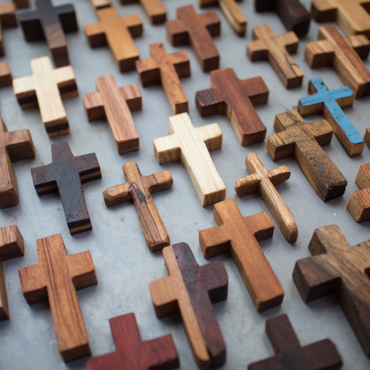 Handmade wooden pocket crosses by Dennehey Design Co. small, detailed wooden crosses perfect for personal or spiritual use.