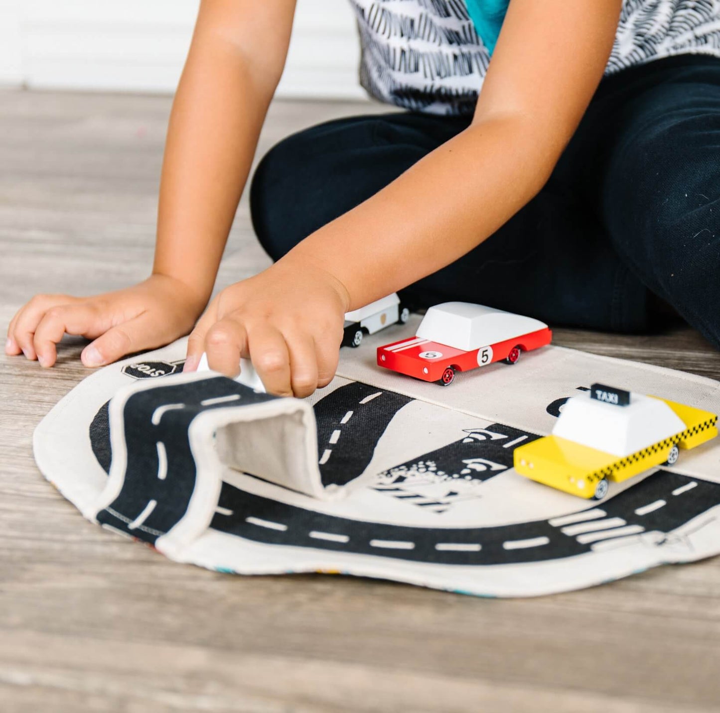 Colorful car play mat by So Handmade Shop featuring roads and buildings, perfect for kids' imaginative play and travel fun.