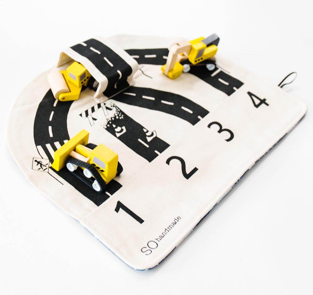 Colorful car playmat by So Handmade Shop featuring roads, cars, and buildings for kids' imaginative play.