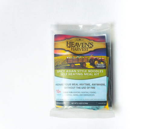 Heaven's Harvest self-heating meal kit with spicy Asian-style noodles in a freeze-dried food package, front view on white background.