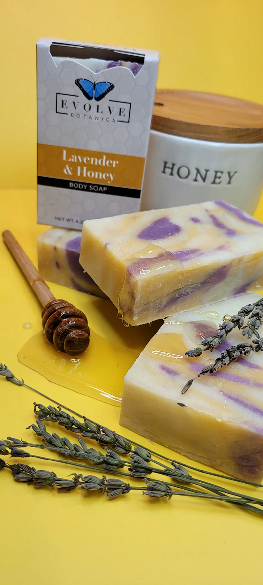 Lavender and honey scented Evolve Botanica standard soap bar with floral lavender flowers and honey drizzles visible.