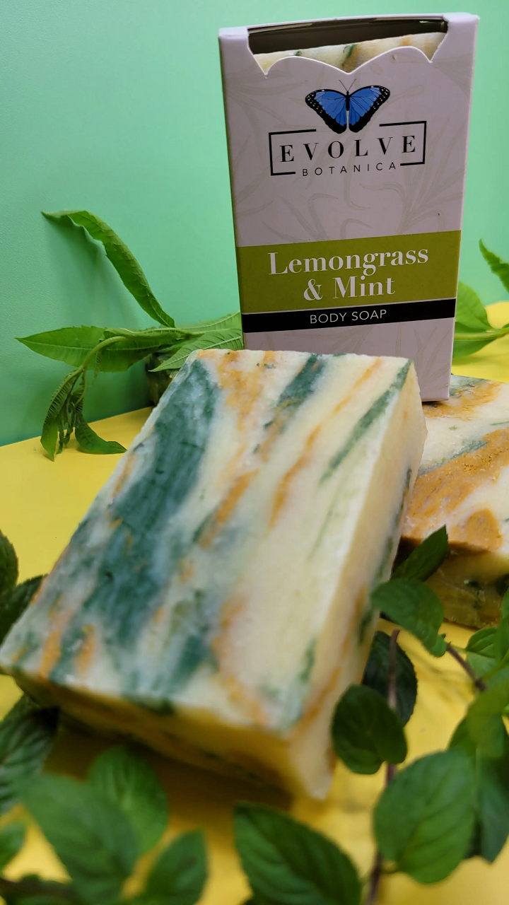 Evolve Botanica Lemongrass & Mint standard soap bar with fresh lemongrass and mint herbs, wrapped in natural paper packaging.