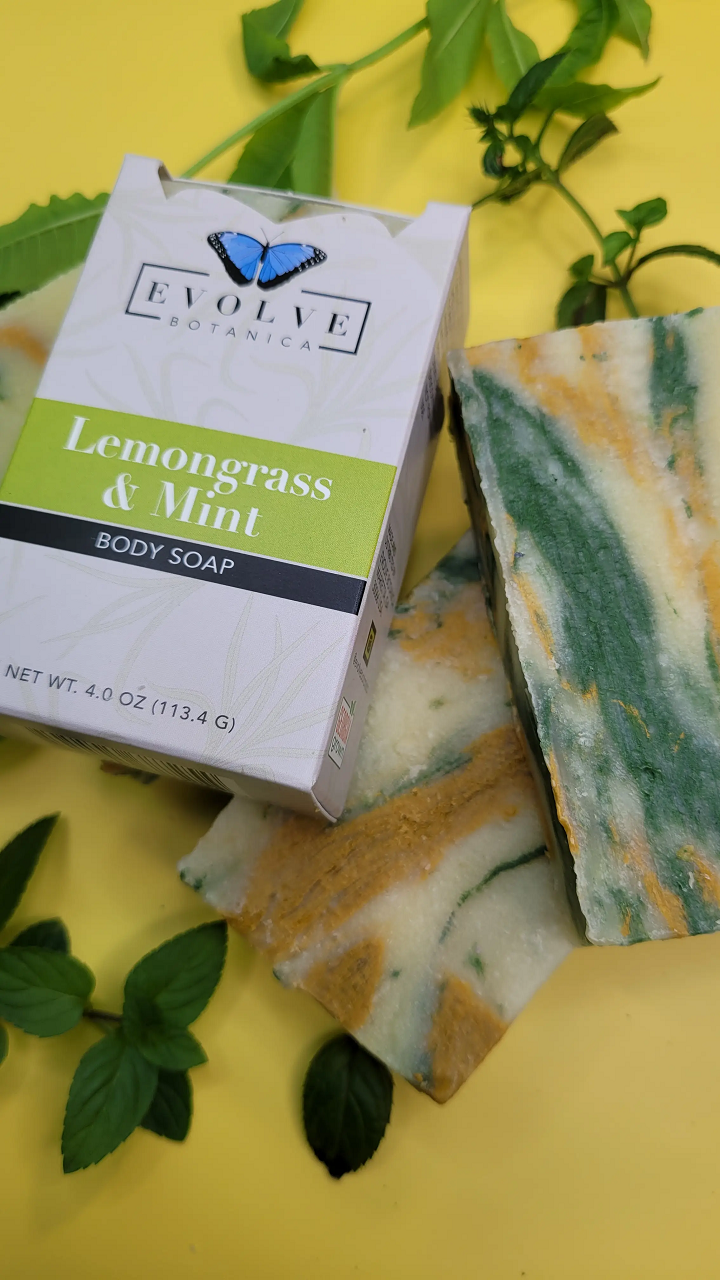 Evolve Botanica Lemongrass & Mint Standard Soap bar with fresh lemongrass and mint ingredients, showing the soap's textured surface.