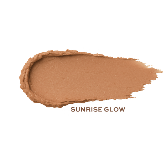 Cream bronzer by Taylor Made Organics with organic ingredients, shown as a warm sun-kissed swatch on skin.