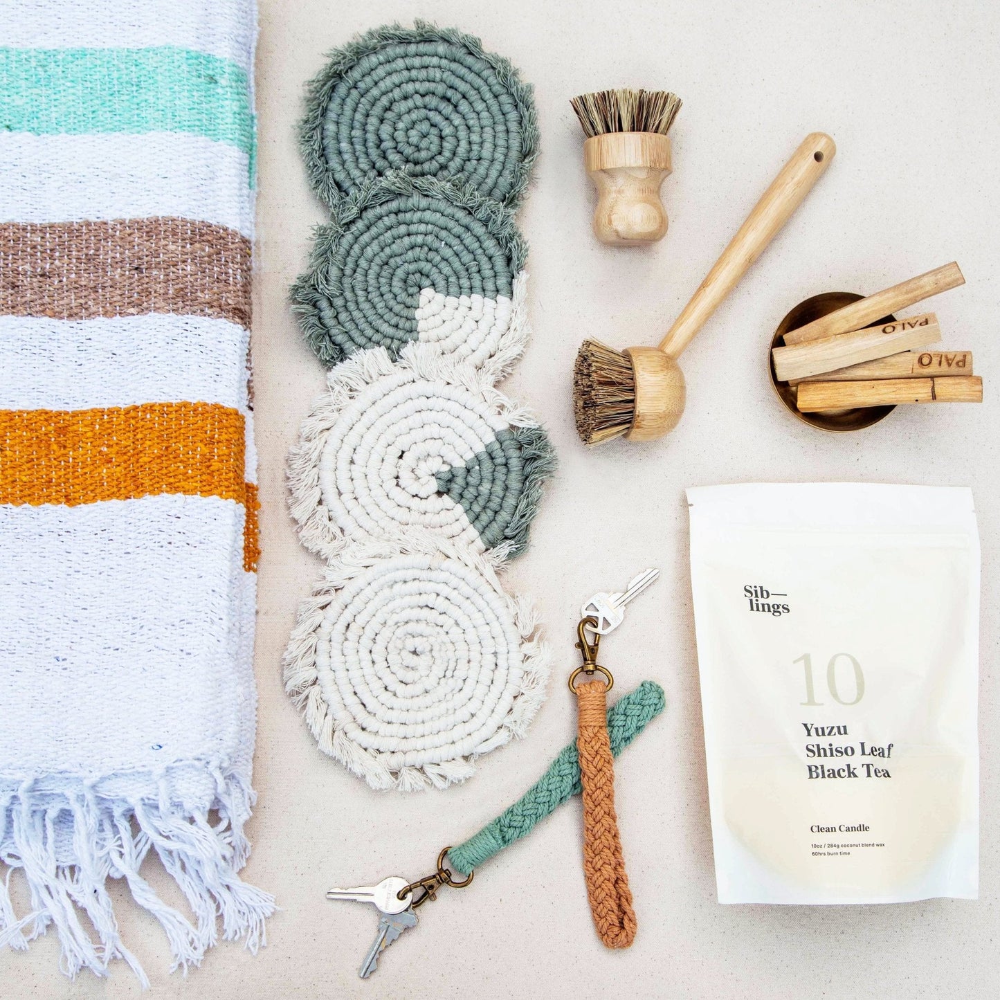 Set of four handmade macrame coasters by Tilley + Me, boho-style drink mats with intricate knot patterns for table decor.