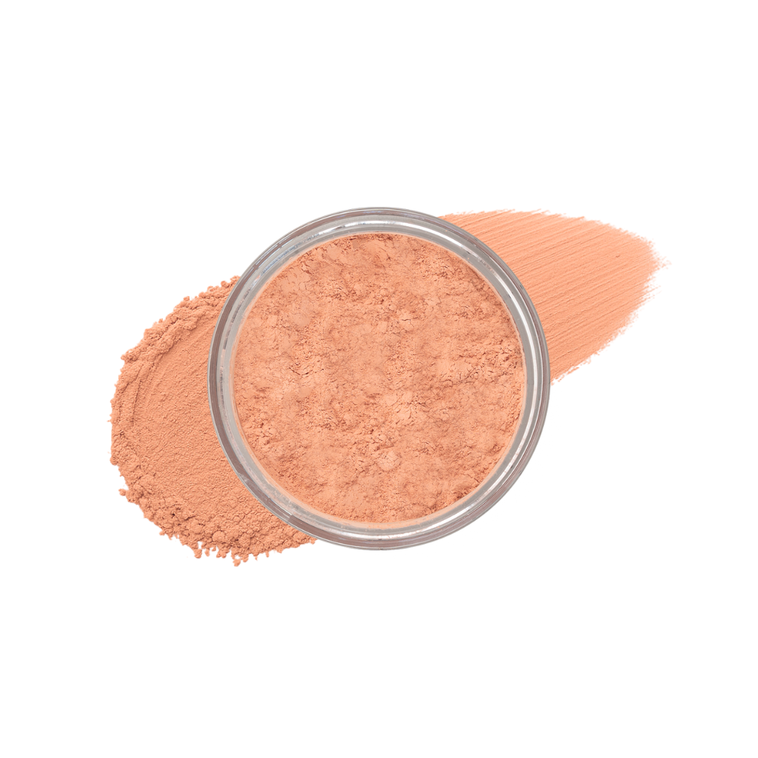 Tan loose mineral foundation in a jar, showing smearing texture, by Taylor Made Organics.
