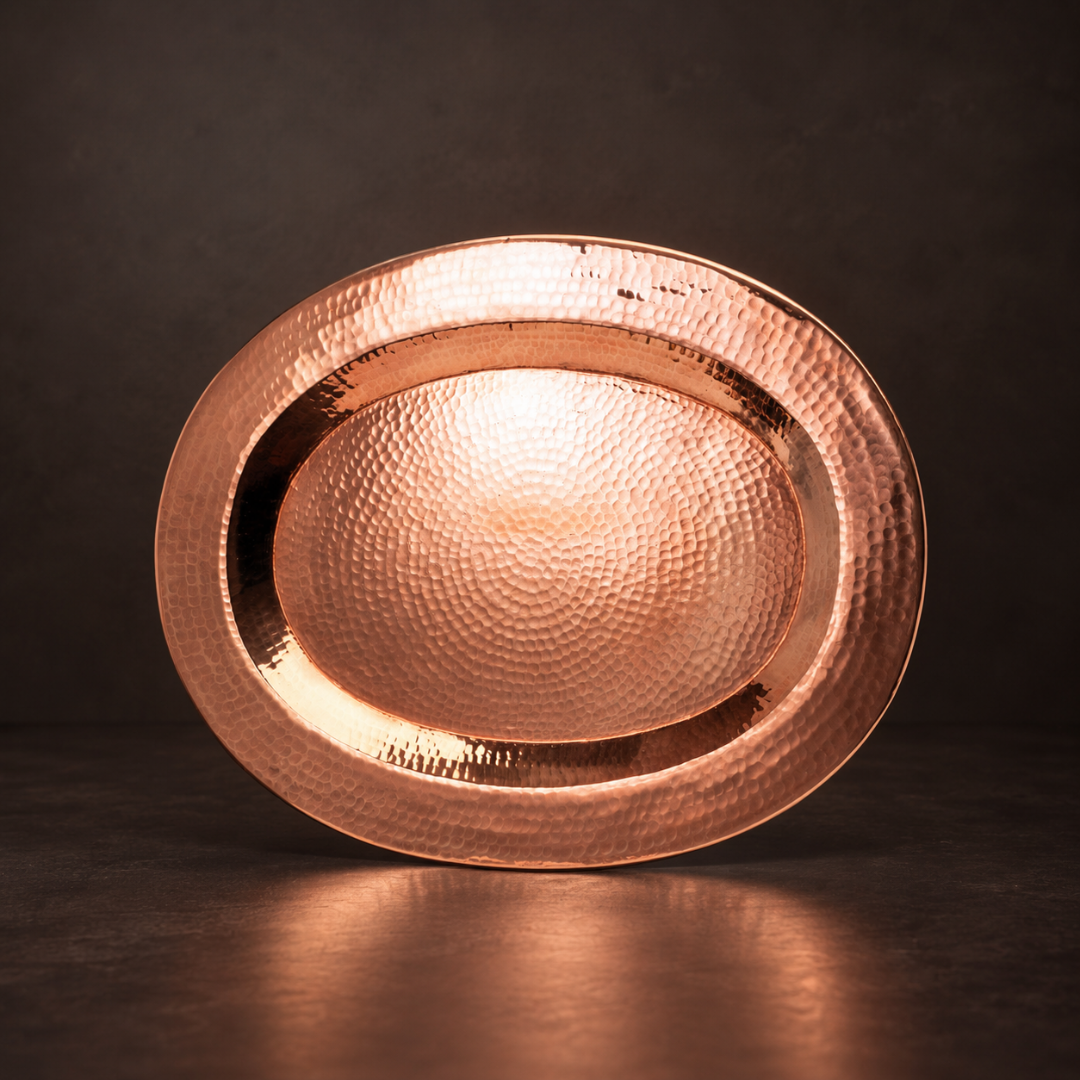 Sertodo Thessaly oval copper platter with hammered finish, ideal for serving appetizers or main dishes on a stylish table.