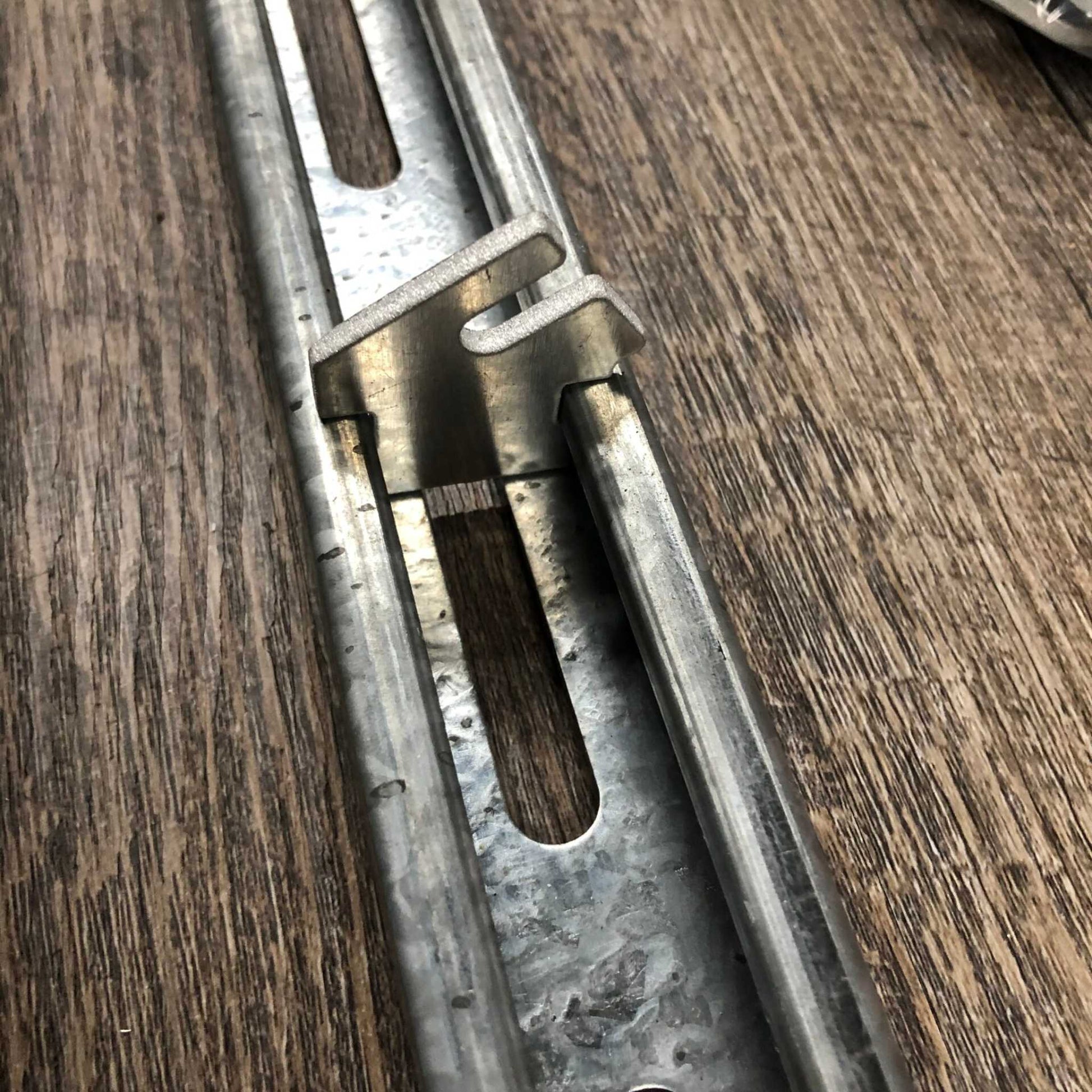 Bootstrap Farmer Twist-Lok keys installed on a track, showing secure attachment and easy locking mechanism for agricultural setup.