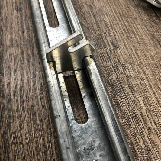 Bootstrap Farmer Twist-Lok keys installed on a track, showing secure attachment and easy locking mechanism for agricultural setup.