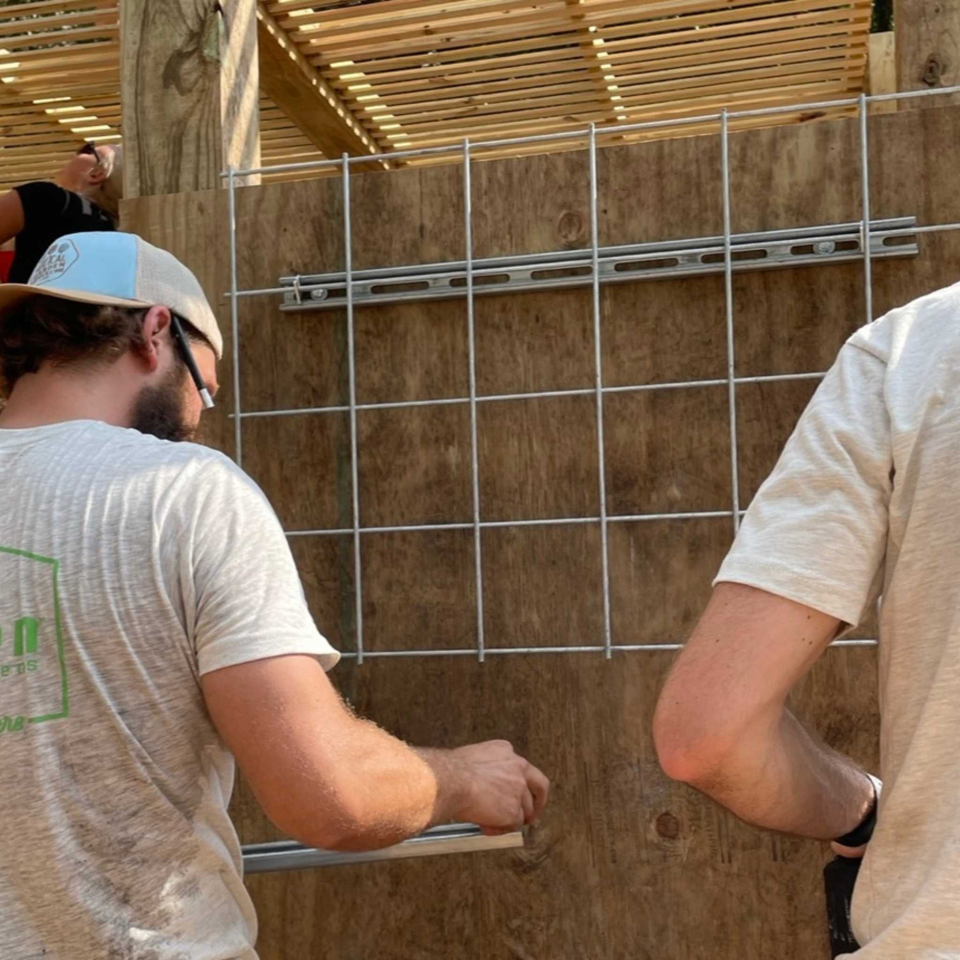 Bootstrap Farmer Twist-Lok Keys installing wire mesh for secure and easy fencing setup.