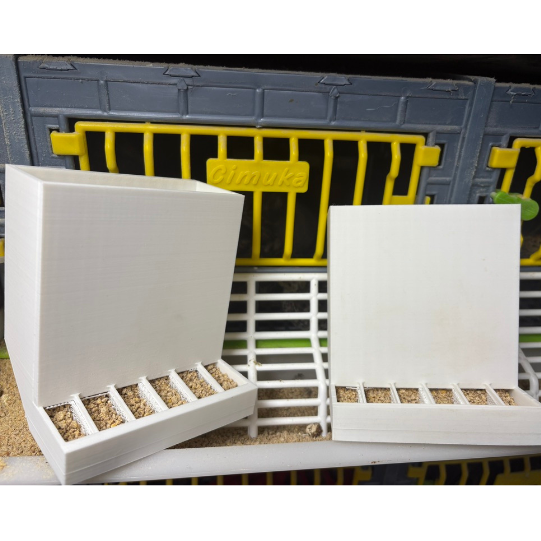 Pair of Quailz.com Button Quail Feeders with adjustable, spill-resistant design for effective bird feeding in animal husbandry.