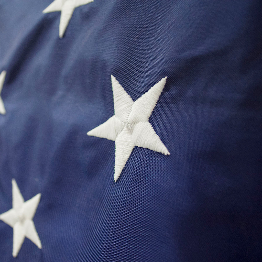 Liberty™ Nylon American flag with stars, made in USA, featuring vibrant red, white, and blue colors, displayed outdoors.