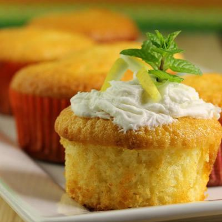 Gluten-free lemon cupcake mix in a 16 oz package by Heartland Gourmet, with fresh lemon slices and cupcakes on a plate.