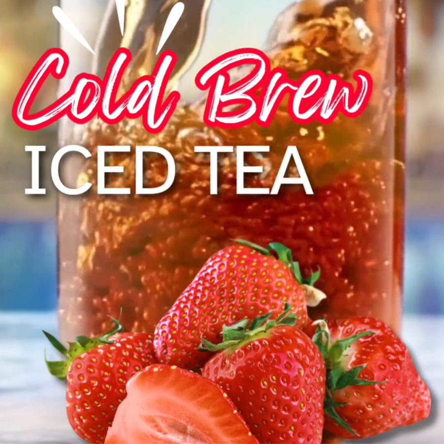 Cold brew black strawberry tea in a glass pitcher with fresh strawberries, showcasing the beverage made with Tea n More pitcher bags.