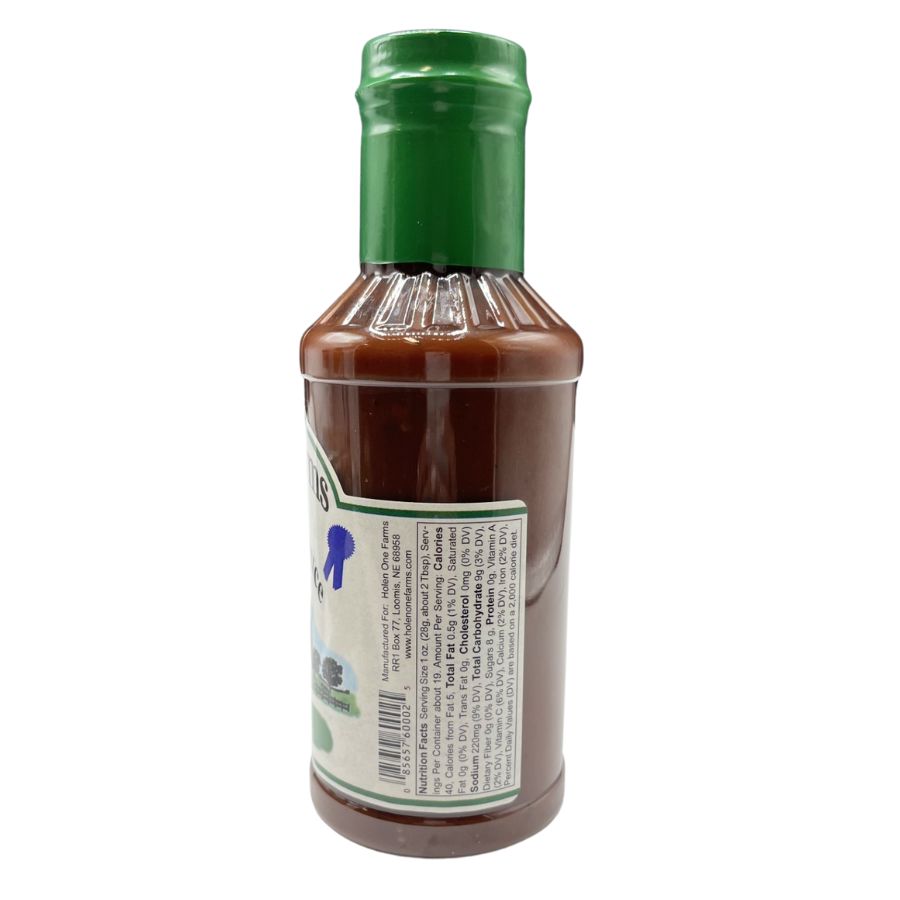 Assorted marinade, barbecue sauce, and seasoning bottles from Holen One Farms food bundle, arranged on a wooden surface.