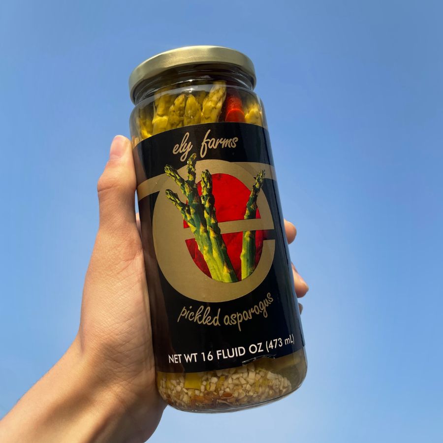 Jar of Ely Farms pickled asparagus spears in a 16 oz glass jar, showcasing vibrant green asparagus with a pickling brine