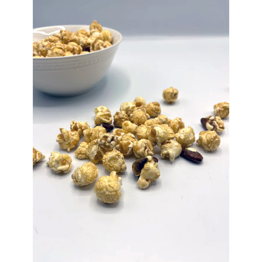 Almond crunch popcorn in an 8 oz bag from HR Poppin' Snacks, featuring golden popcorn with almond pieces.